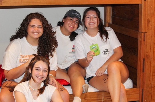 Seniors Hailey Martens (back left), Abby Holshouser (bottom left), Natalie Casarrubias (middle), and Bianca Alexson (back right) gather together in one bunk. They chatted about life and braided hair before color wars.