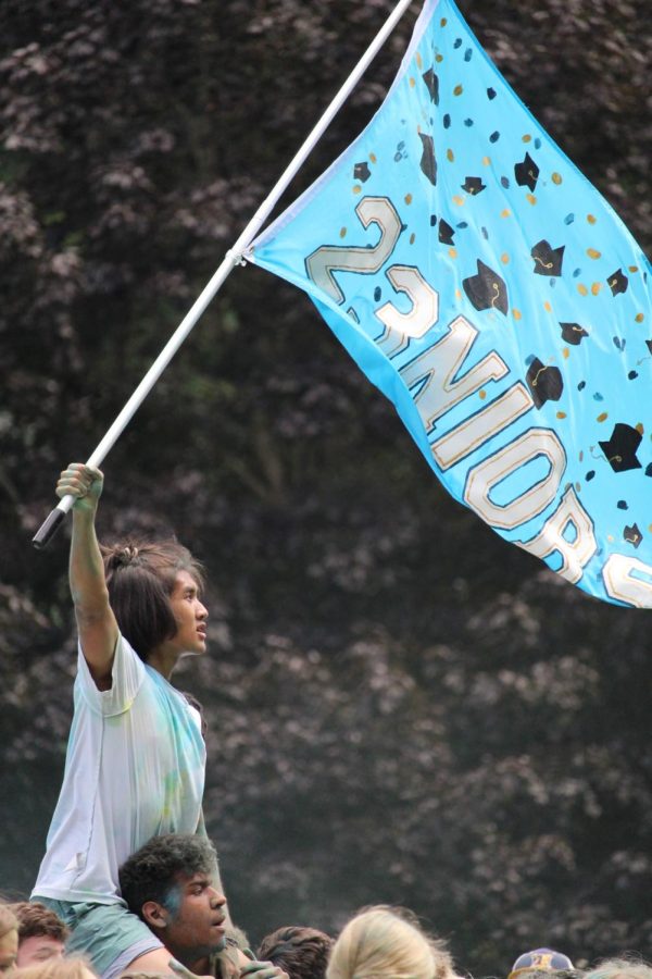 Senior Stephan Tathio waves the senior flag as he charges into the 2022 color wars. Stephan had great school spirit and was so excited to participate.
