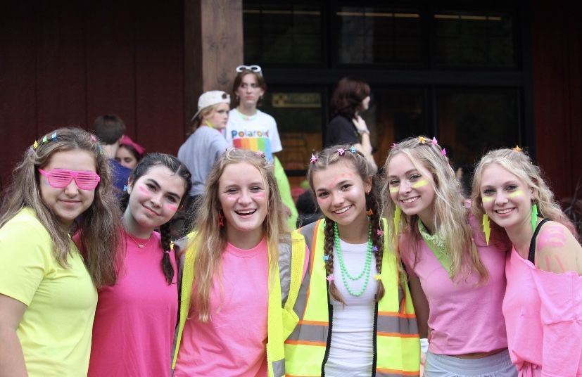 From left, sophomore girls gather together before heading into the dining hall for dinner. They showed their spirit on the last night at Windy Gap by going all out for Neon night.
