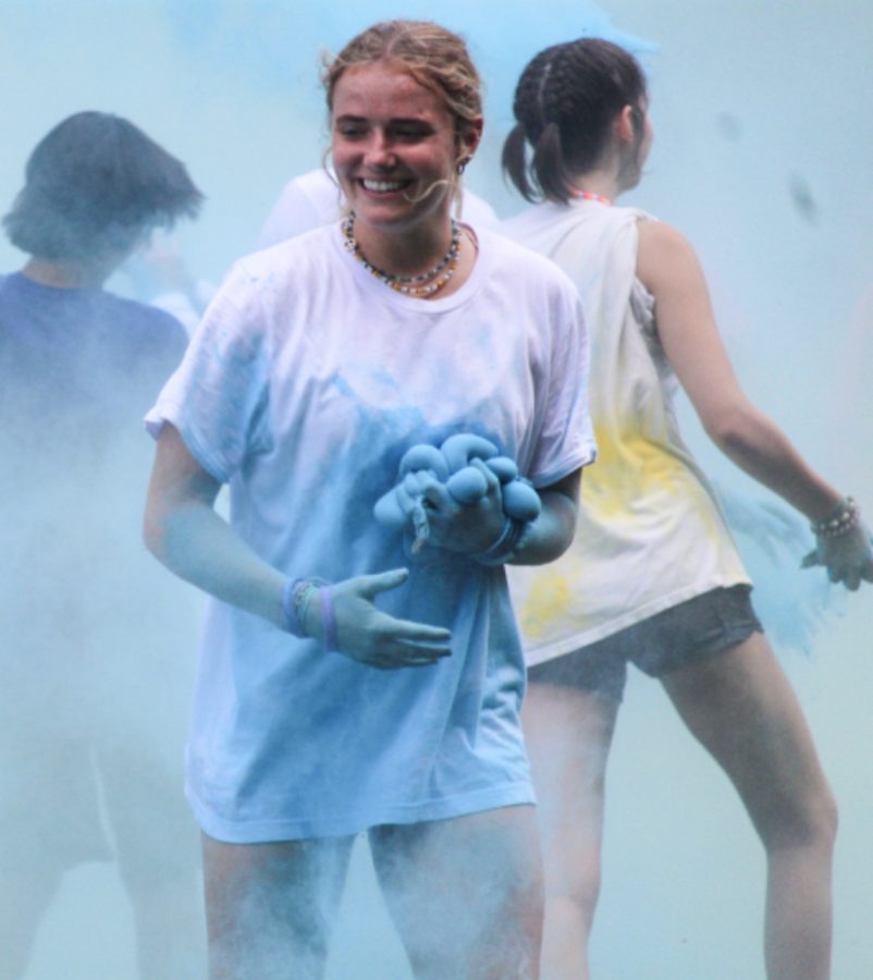 Senior Jordan Alexander holds blue color bombs. She was excited to participate in the 2022 color wars.