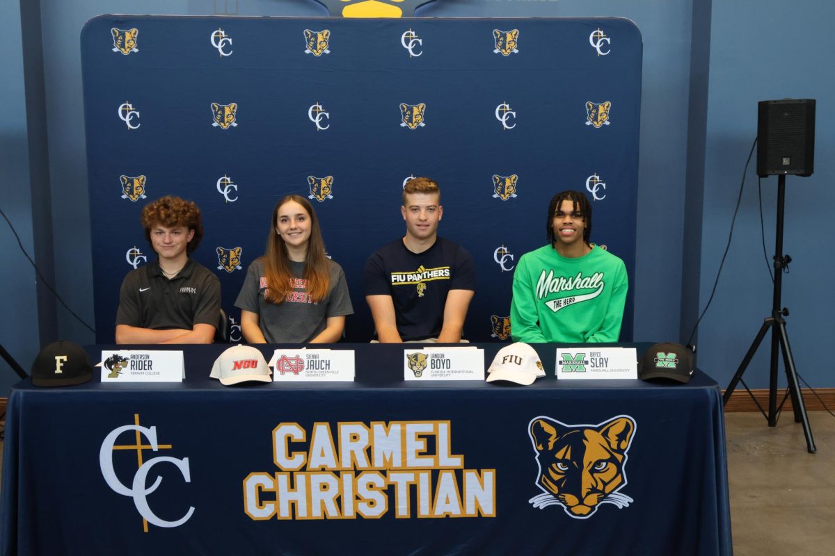 All four student athletes pictured here before they sign their National Letter of Intent.